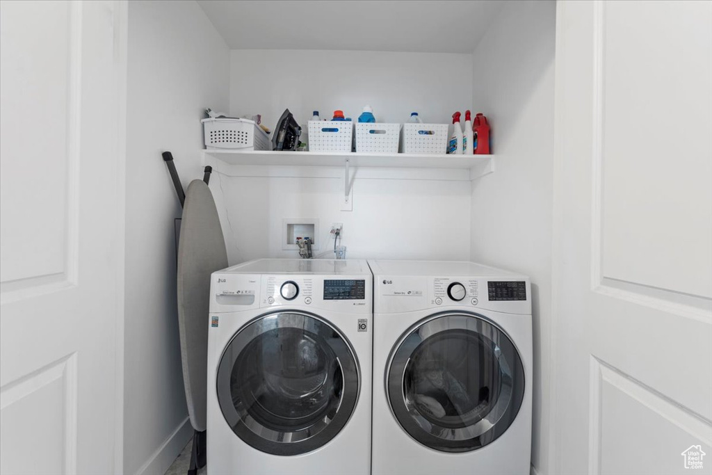 Washroom with washer and clothes dryer