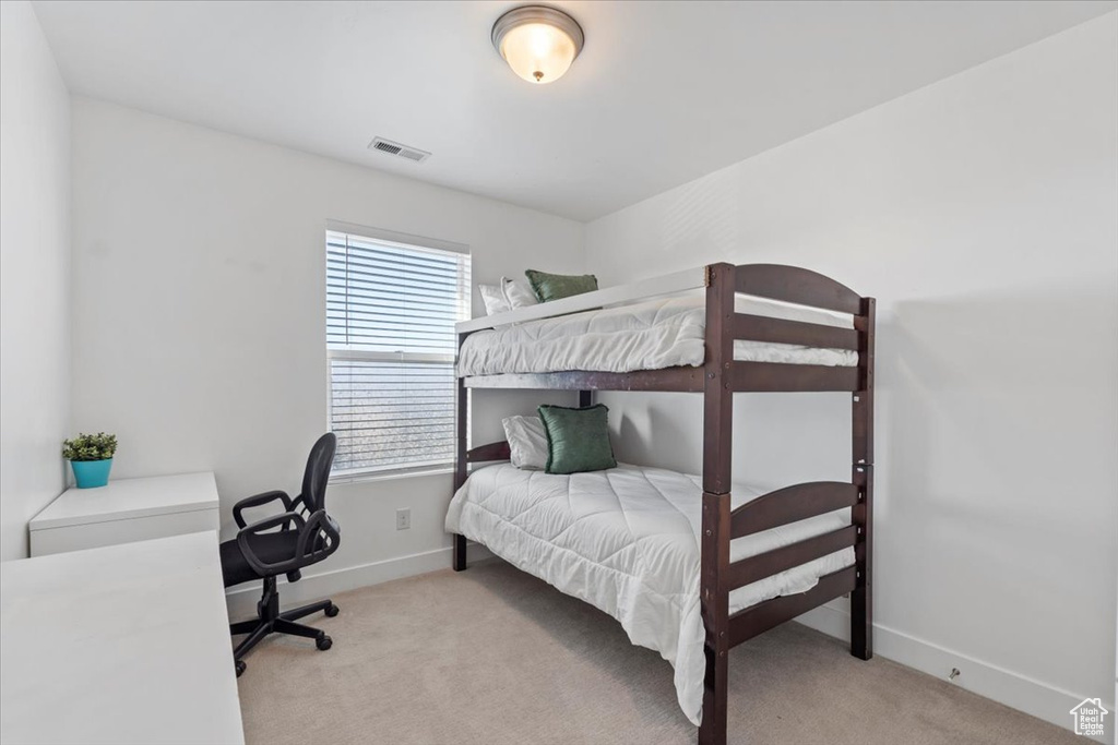 Bedroom with light colored carpet