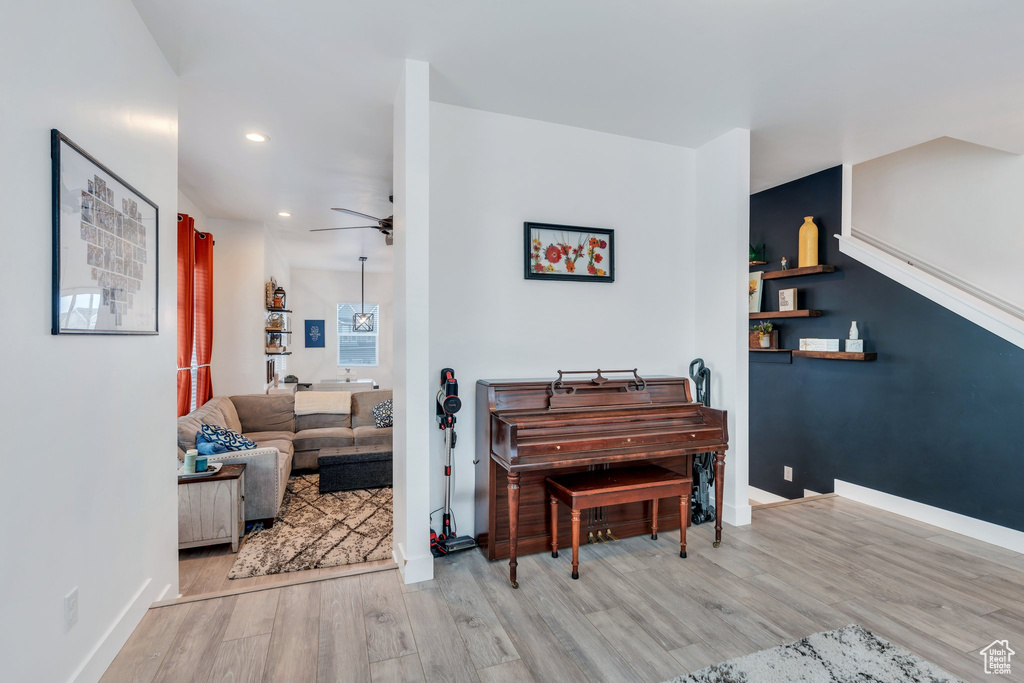 Interior space featuring baseboards, recessed lighting, a ceiling fan, and wood finished floors