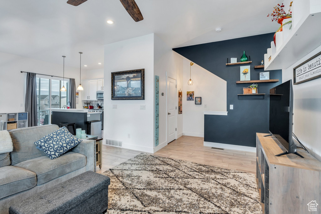 Living room featuring ceiling fan, recessed lighting, baseboards, light wood-type flooring, and visible vents