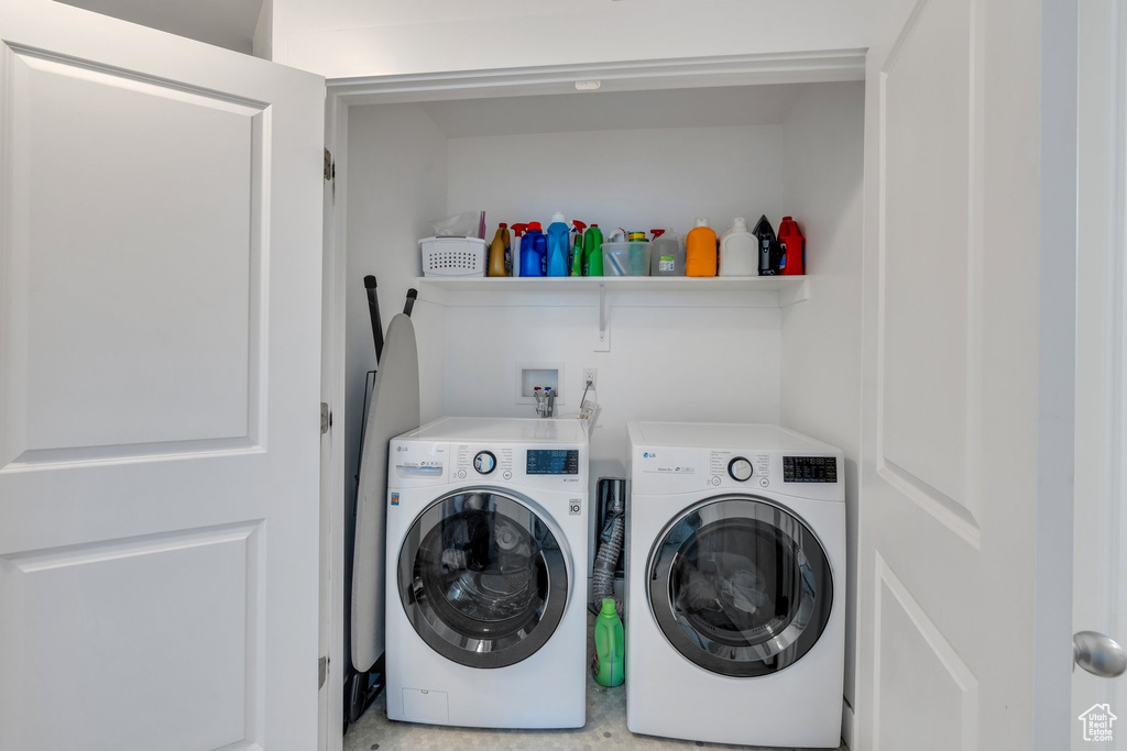 Washroom with laundry area and washer and clothes dryer