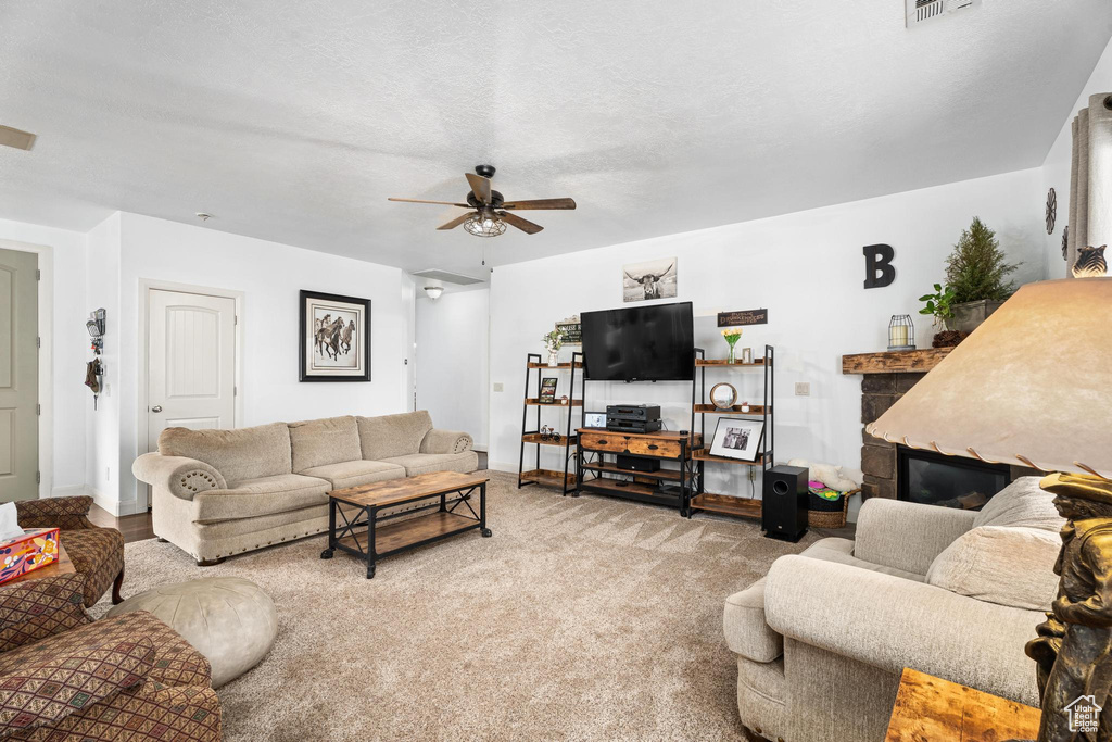 Living area featuring baseboards, a ceiling fan, and visible vents