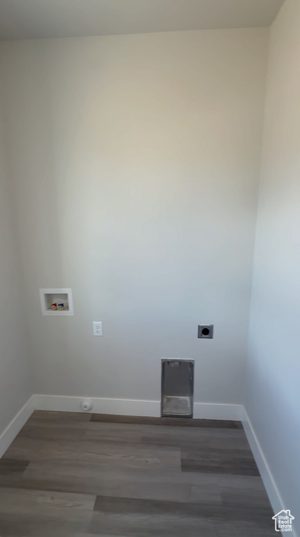 Washroom featuring hookup for an electric dryer, dark wood-style flooring, washer hookup, and baseboards