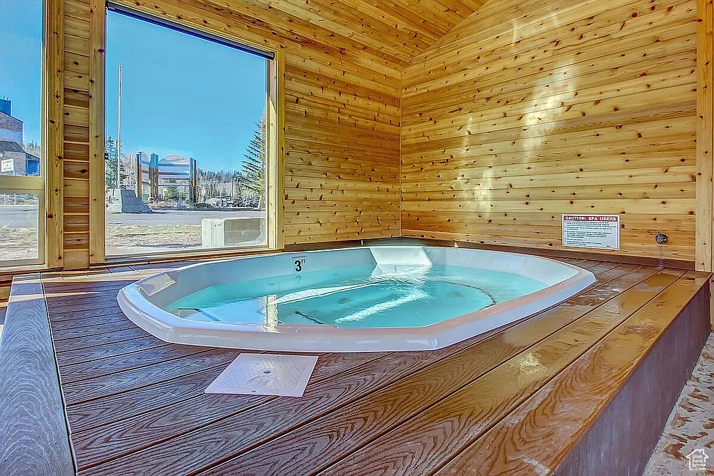 Miscellaneous room with a city view, wooden walls, visible vents, and a jacuzzi