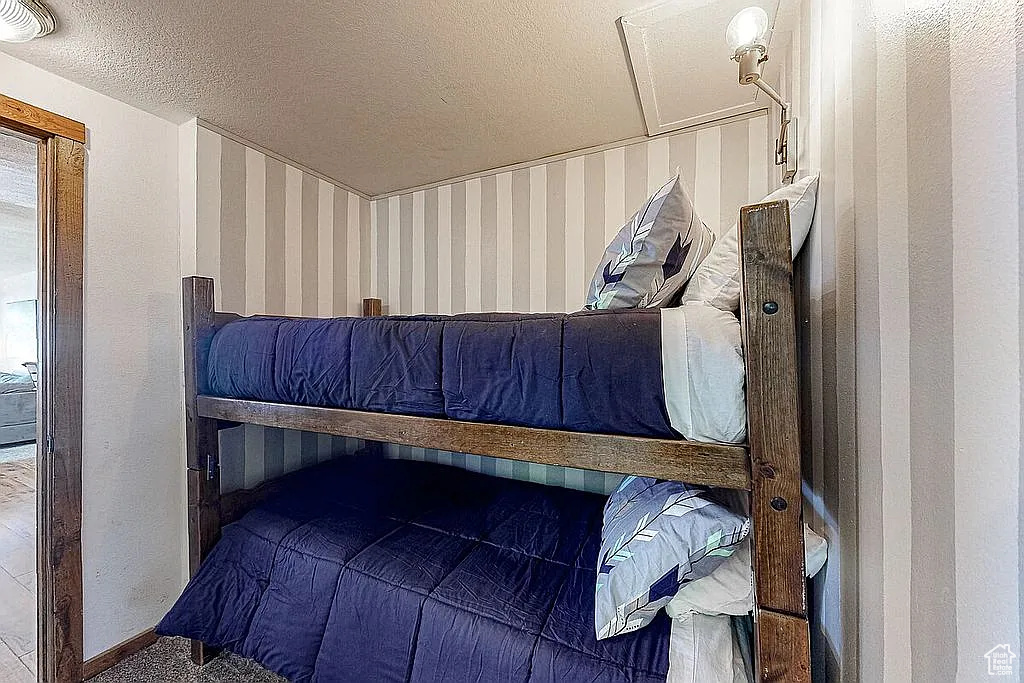 Bedroom with visible vents and a textured ceiling