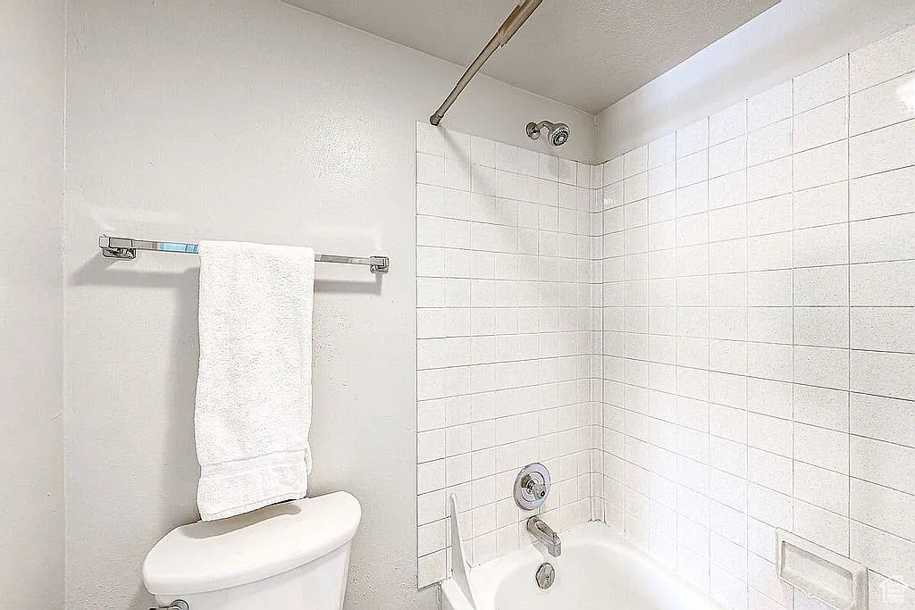 Bathroom with washtub / shower combination and toilet
