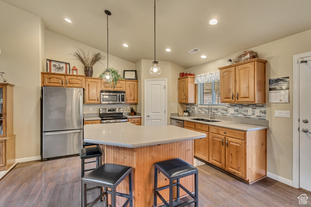 Kitchen with visible vents, a sink, light wood-style floors, and stainless steel appliances