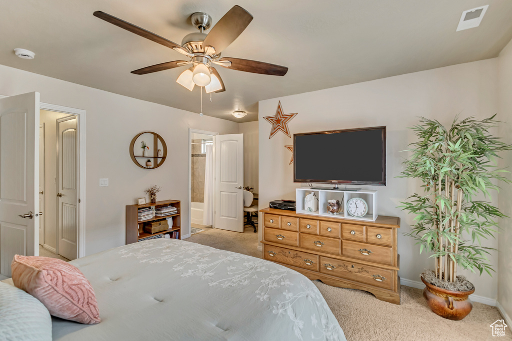 Bedroom with carpet floors, baseboards, a ceiling fan, and connected bathroom