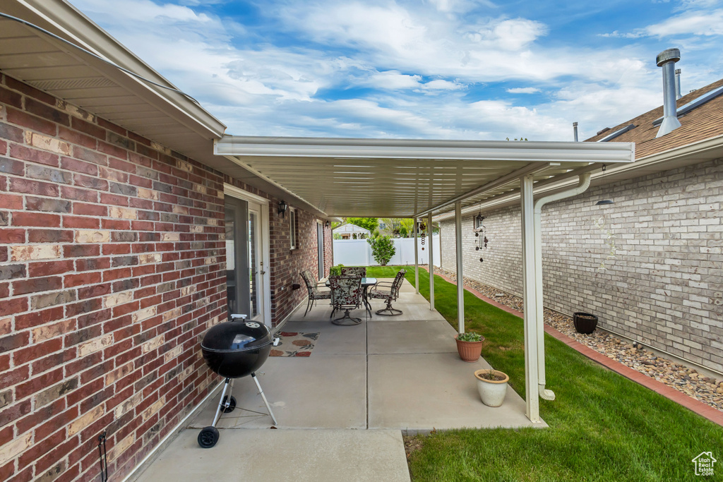 View of patio with area for grilling and fence