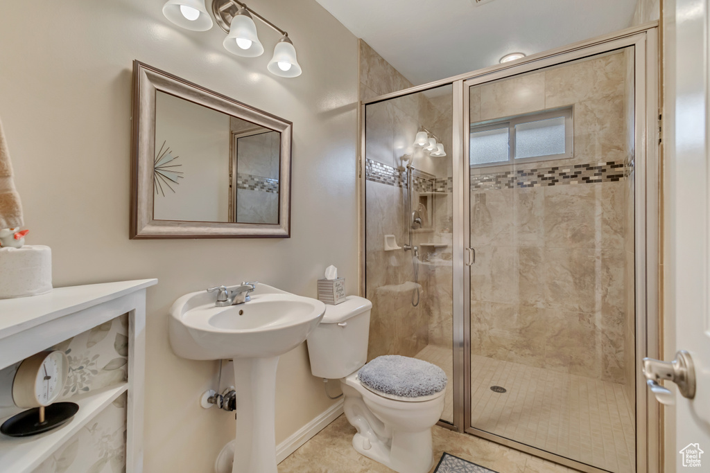 Full bathroom featuring tile patterned floors, a shower stall, and toilet