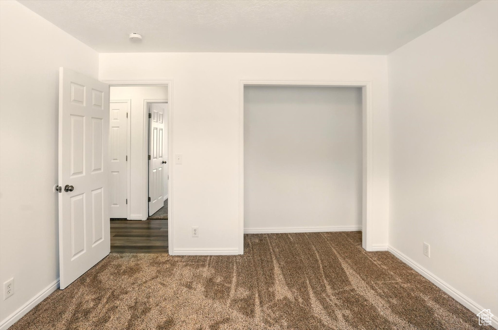Unfurnished bedroom featuring carpet flooring and baseboards