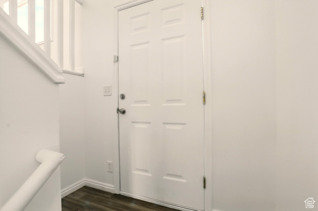 Doorway to outside with baseboards and dark wood finished floors