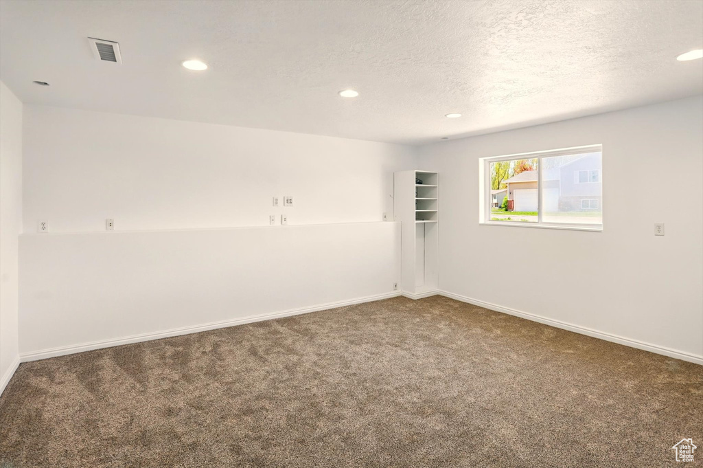 Spare room with carpet floors, recessed lighting, baseboards, and visible vents