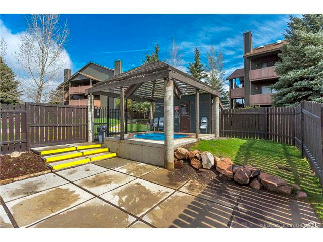 View of patio / terrace featuring a gazebo, a fenced backyard, and a hot tub