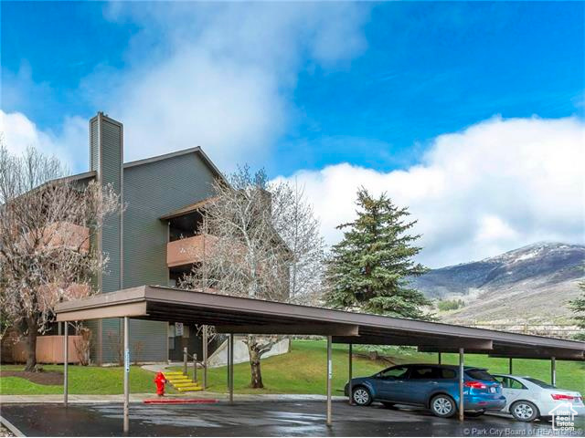 Covered parking lot featuring a mountain view