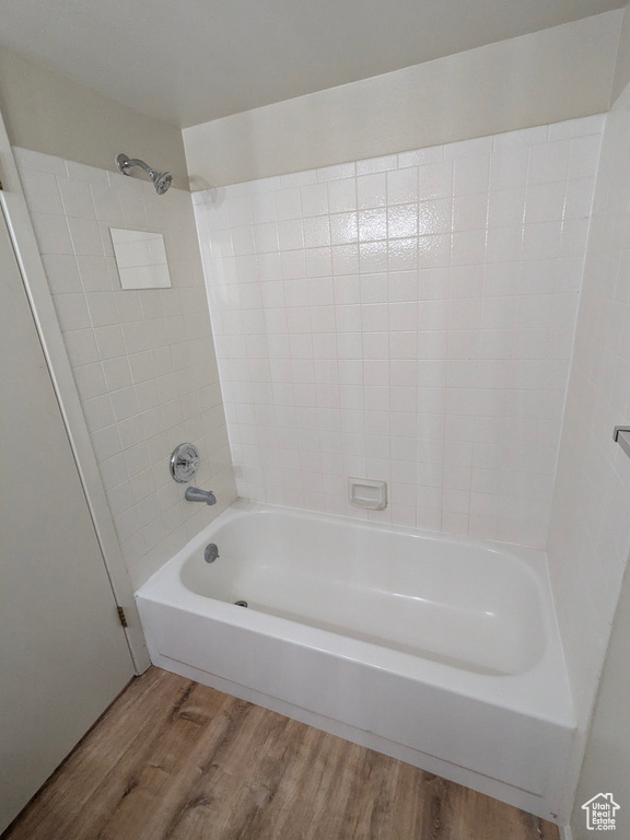 Bathroom featuring shower / tub combination and wood finished floors
