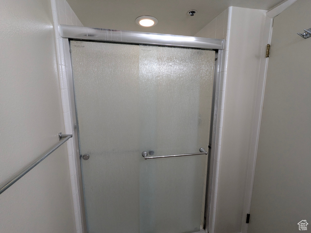 Bathroom featuring recessed lighting and a shower stall