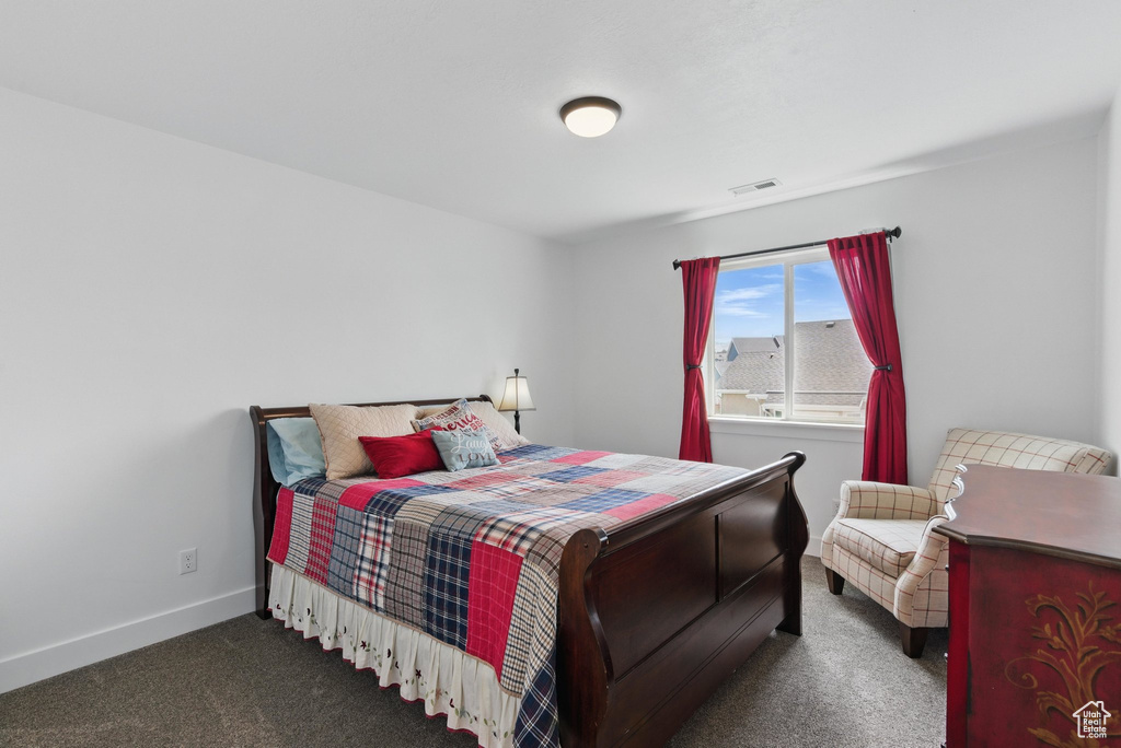 Bedroom with baseboards, carpet, and visible vents