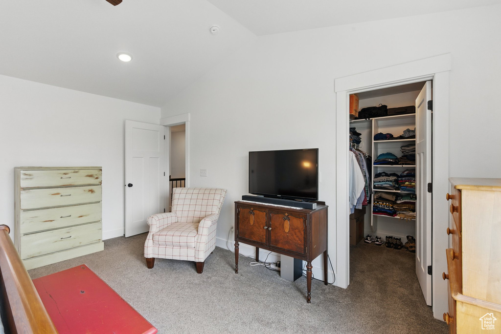 Living area featuring carpet floors and lofted ceiling