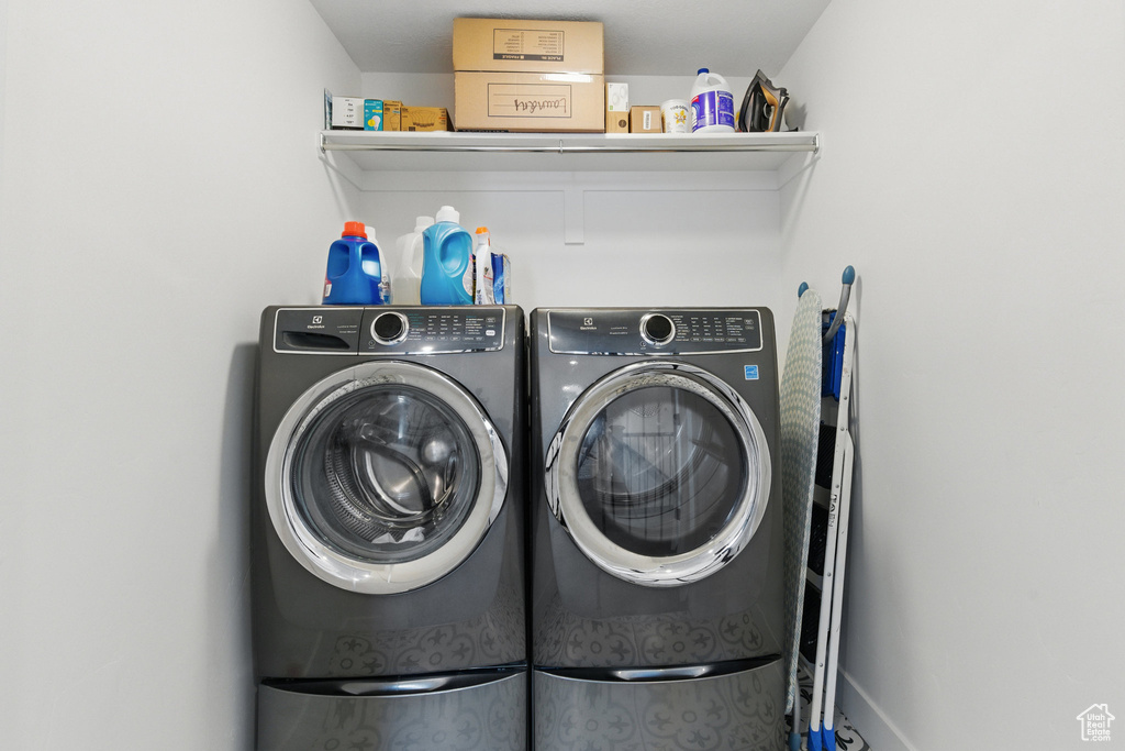 Laundry area featuring separate washer and dryer and laundry area