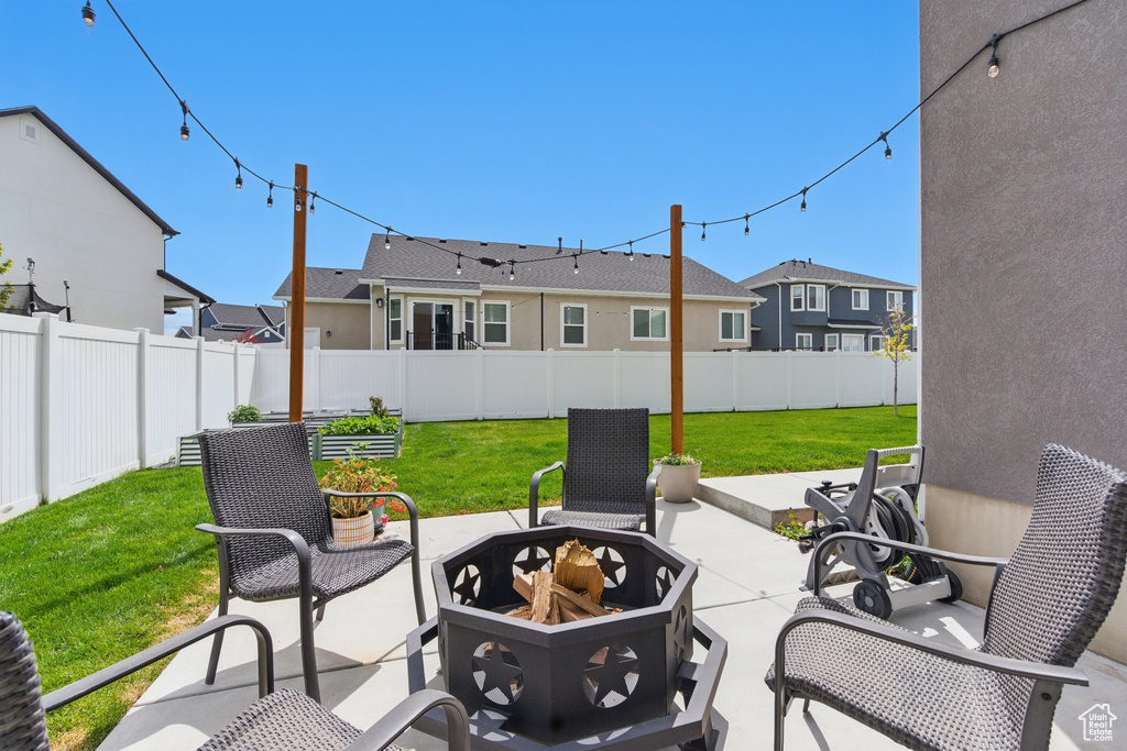 View of patio / terrace with a fenced backyard, an outdoor fire pit, and a residential view