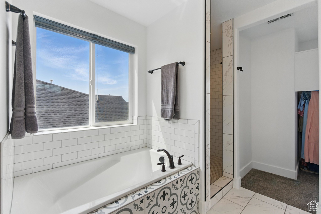 Full bath with a walk in shower, marble finish floor, baseboards, visible vents, and a bath