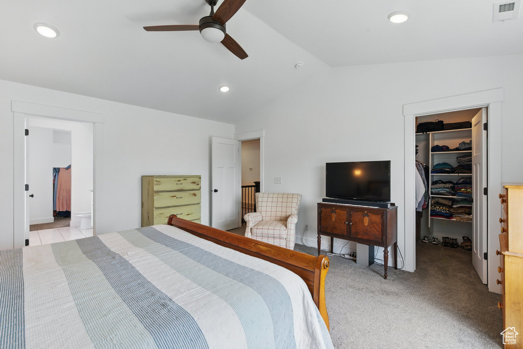 Bedroom featuring a walk in closet, visible vents, a closet, lofted ceiling, and recessed lighting