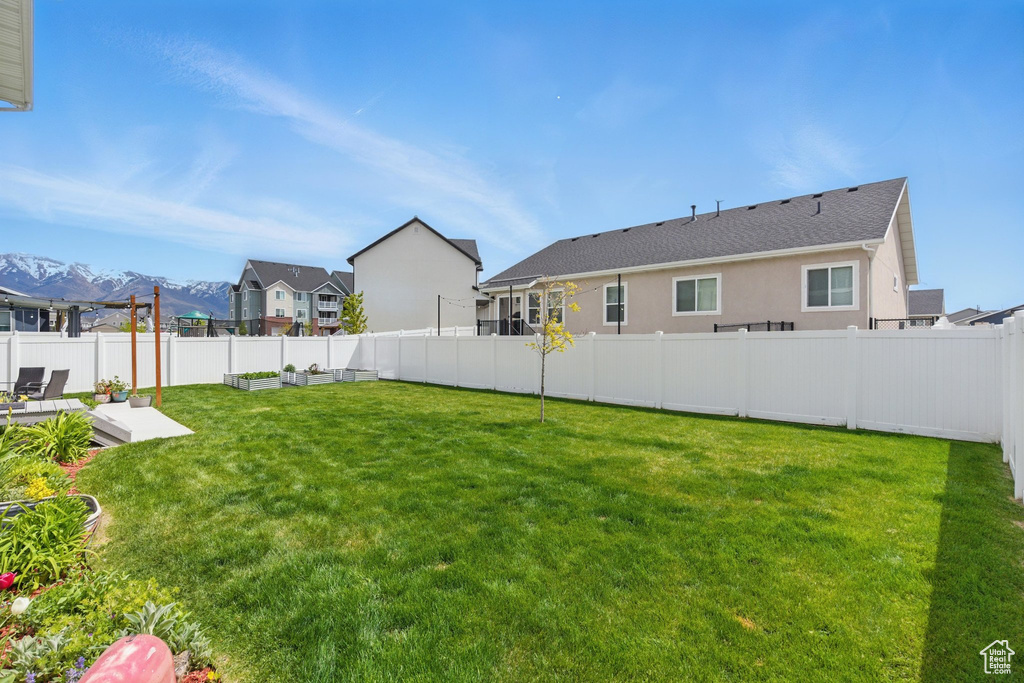 View of yard featuring a fenced backyard and a mountain view