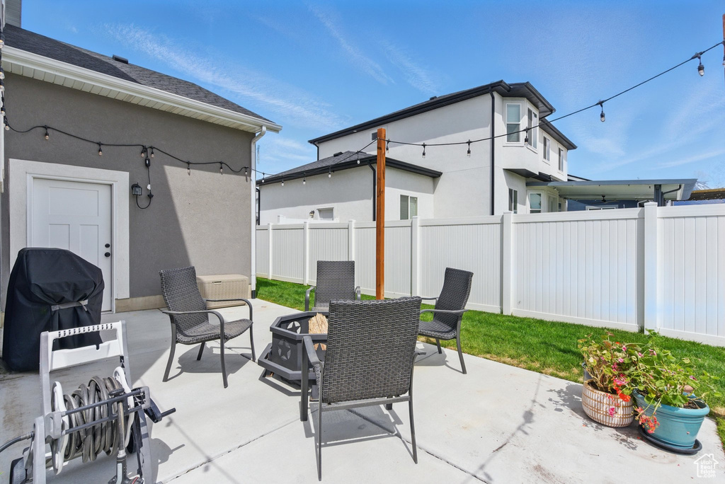 View of patio / terrace featuring a fire pit, fence, and grilling area