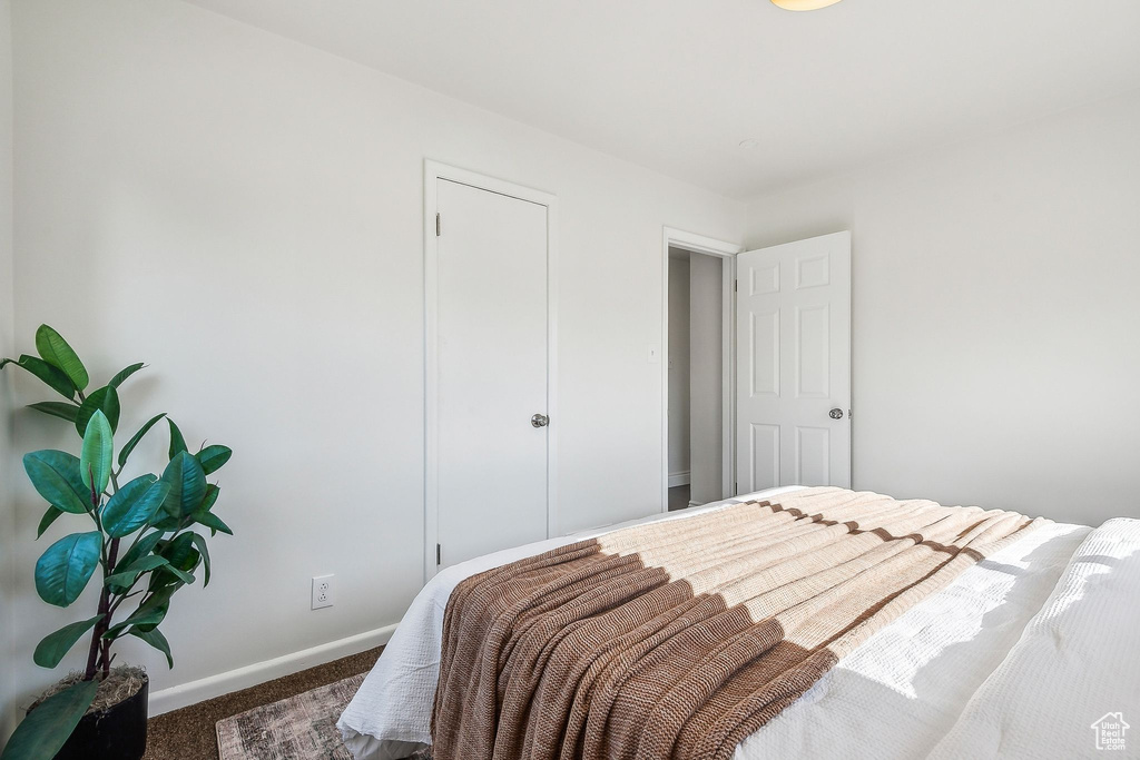 Carpeted bedroom featuring baseboards