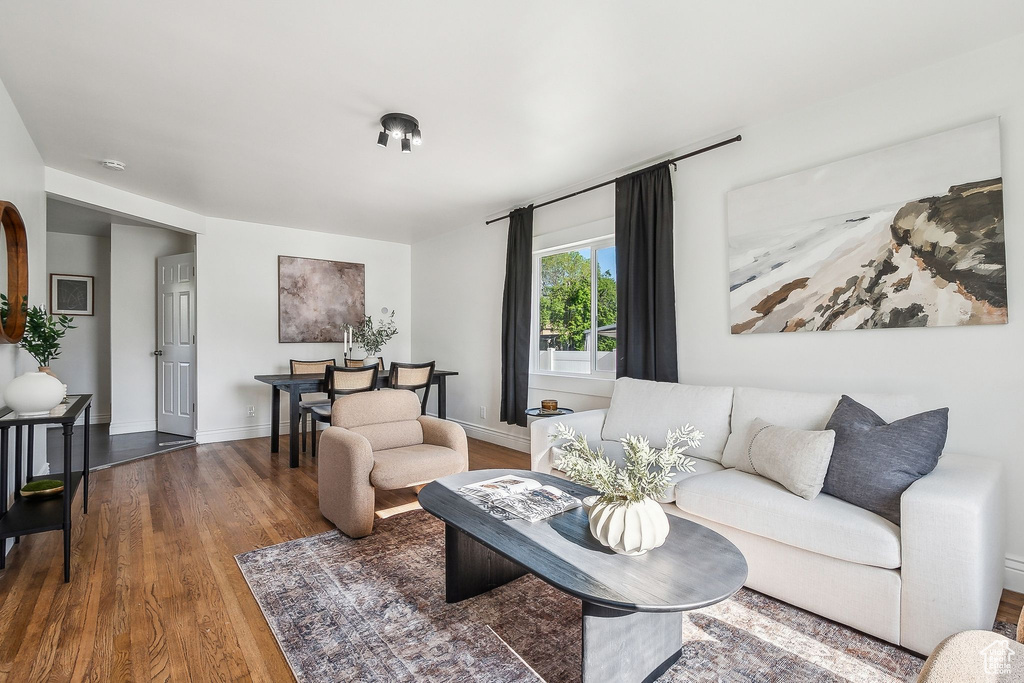 Living area featuring baseboards and wood finished floors