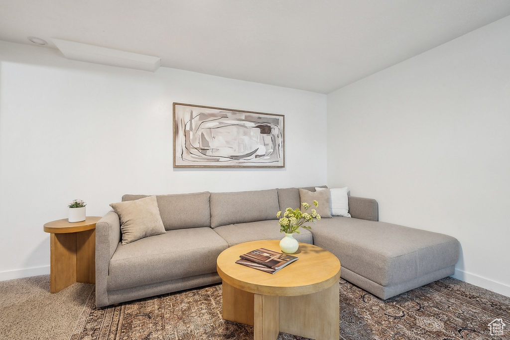 Carpeted living room with baseboards