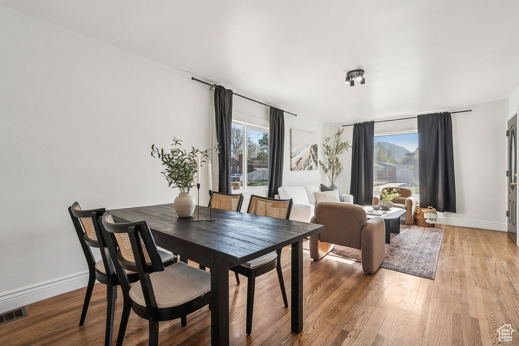 Dining room featuring visible vents, baseboards, and light wood finished floors