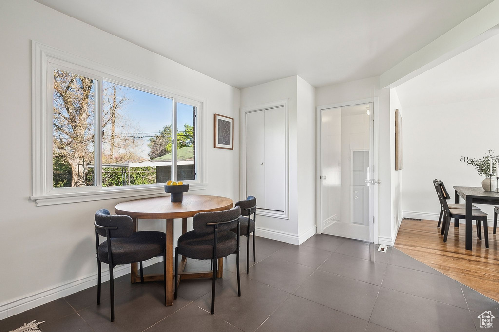 Dining space with baseboards and dark tile patterned floors