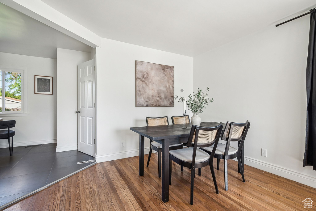 Dining area featuring baseboards and wood finished floors