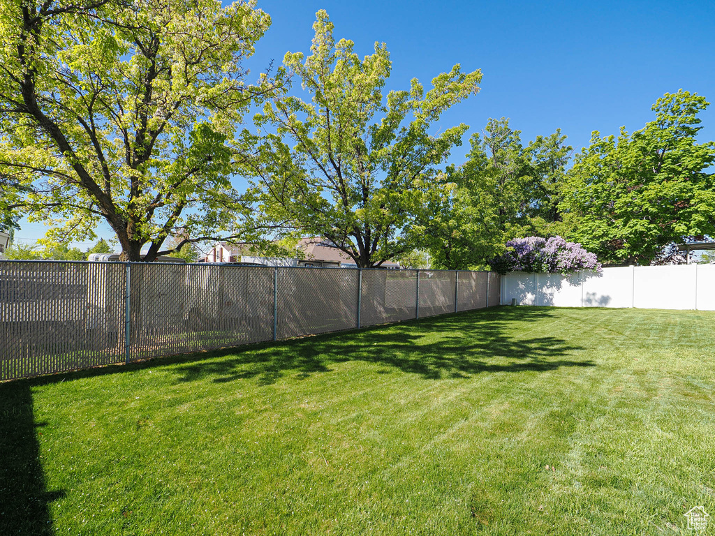 View of yard featuring fence