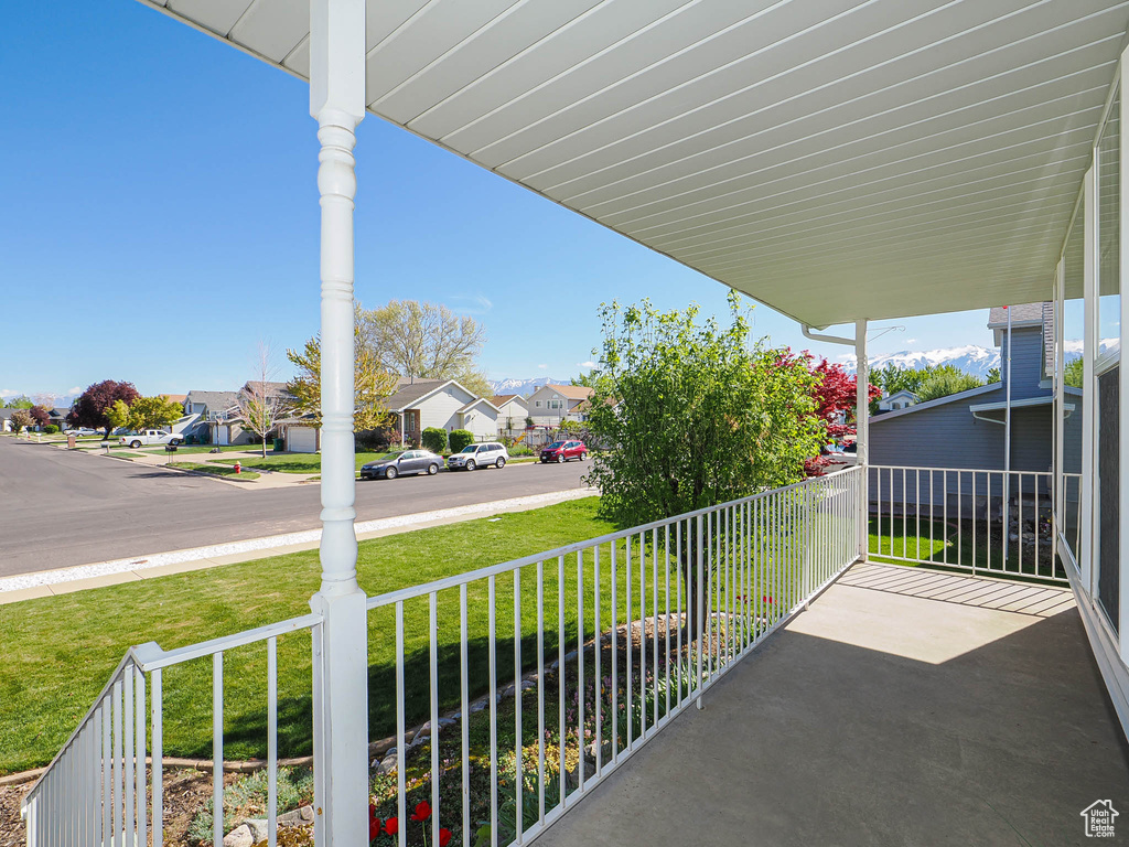 Balcony featuring a residential view and covered porch