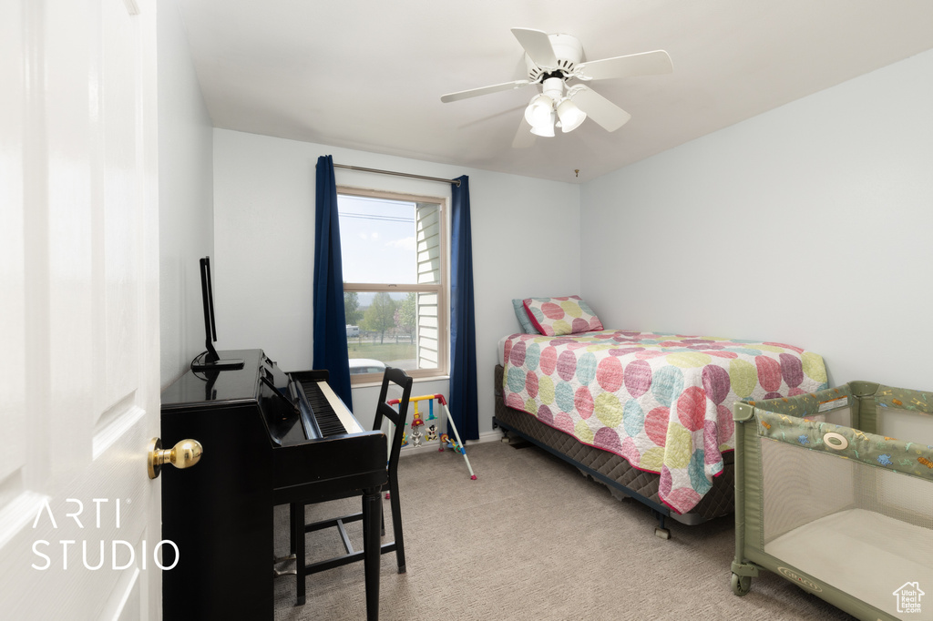 Bedroom with carpet floors, baseboards, and a ceiling fan