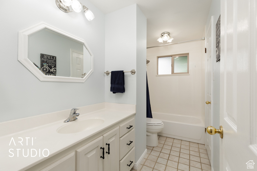 Full bathroom featuring tile patterned flooring, washtub / shower combination, toilet, and vanity