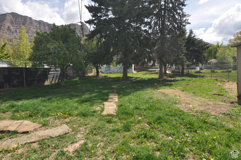 View of yard with fence and a mountain view