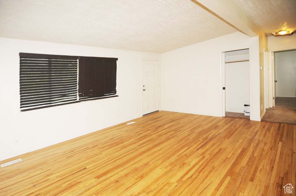 Empty room featuring visible vents and light wood-style floors