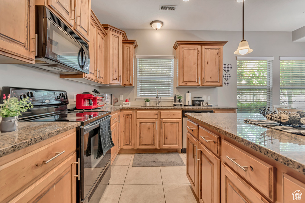 Kitchen featuring visible vents, stainless steel dishwasher, black microwave, electric range oven, and a sink