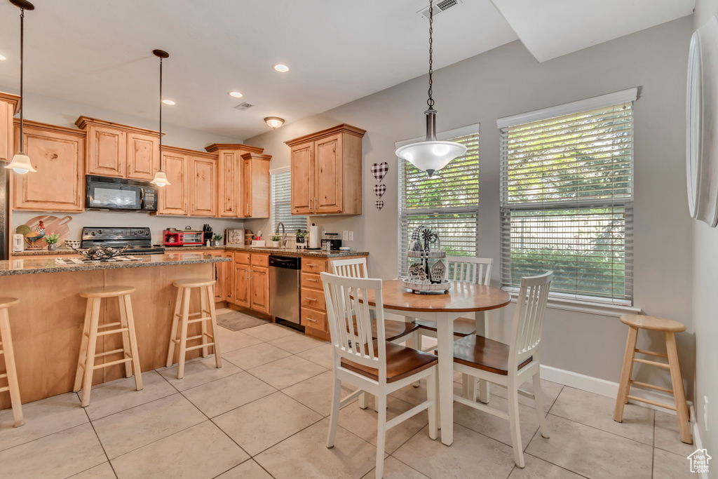 Kitchen featuring a sink, appliances with stainless steel finishes, and a wealth of natural light