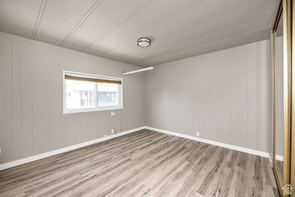 Unfurnished room with baseboards and wood finished floors