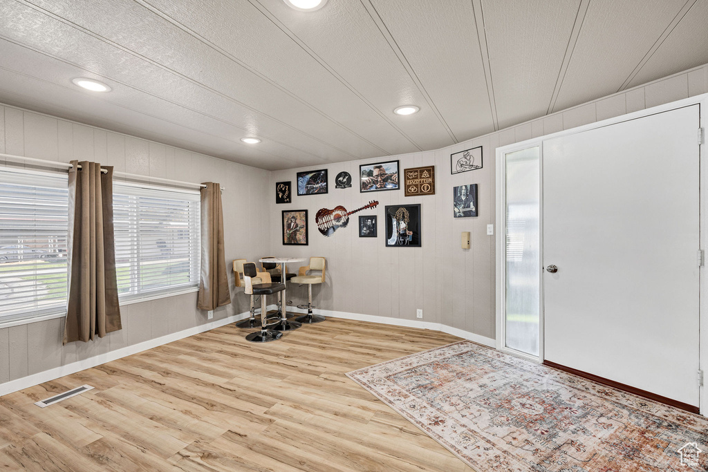 Office area featuring baseboards, recessed lighting, wood finished floors, and visible vents