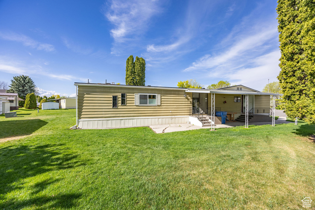 Back of house with a patio, a yard, and entry steps