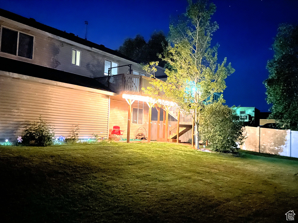 Yard at night with stairway and a balcony
