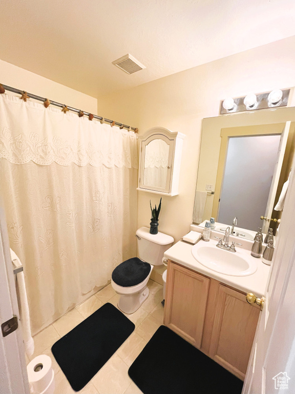 Bathroom featuring visible vents, vanity, toilet, tile patterned floors, and a shower with curtain