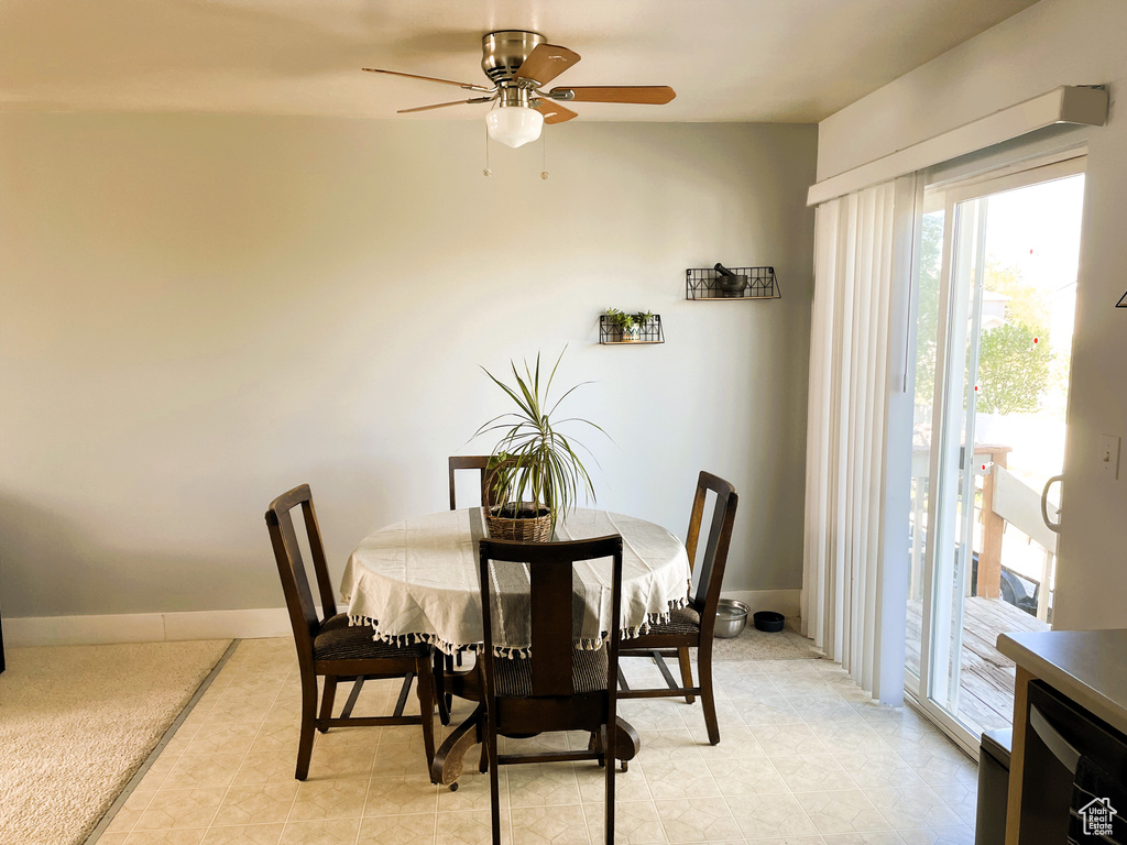 Dining space with baseboards and a ceiling fan