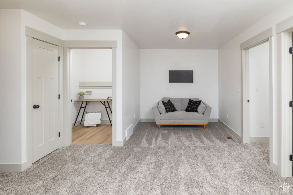 Sitting room featuring baseboards, carpet, and visible vents